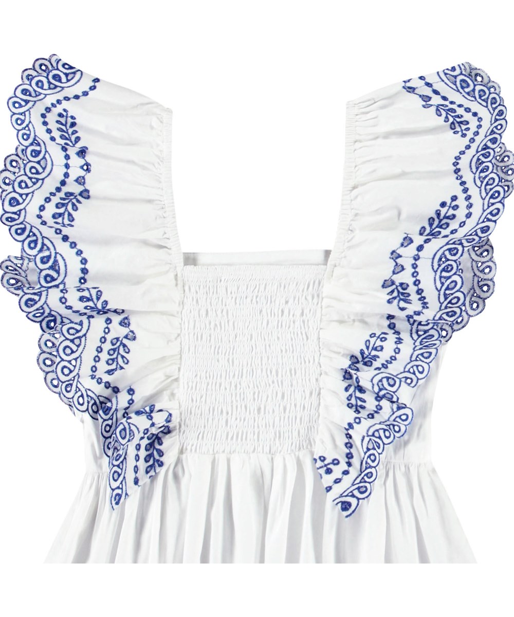 Rosamond - Crisp White - White top for children in organic cotton with blue embroidery on the ruffle sleeves.