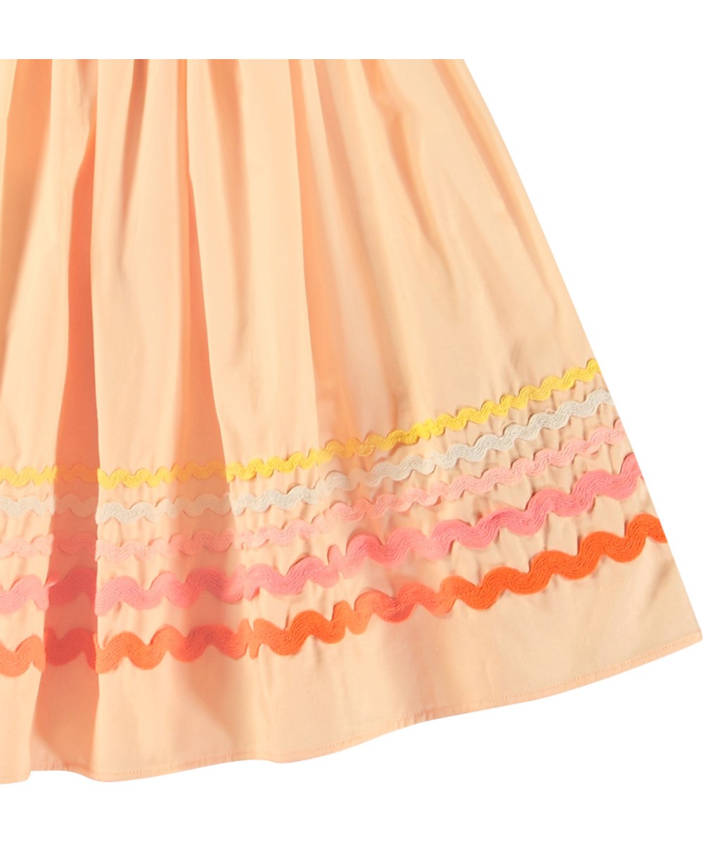 Bini - Pale Melon - Peach-coloured skirt in organic cotton for children. Multi-coloured wavy-effect trim at the bottom of the skirt.
