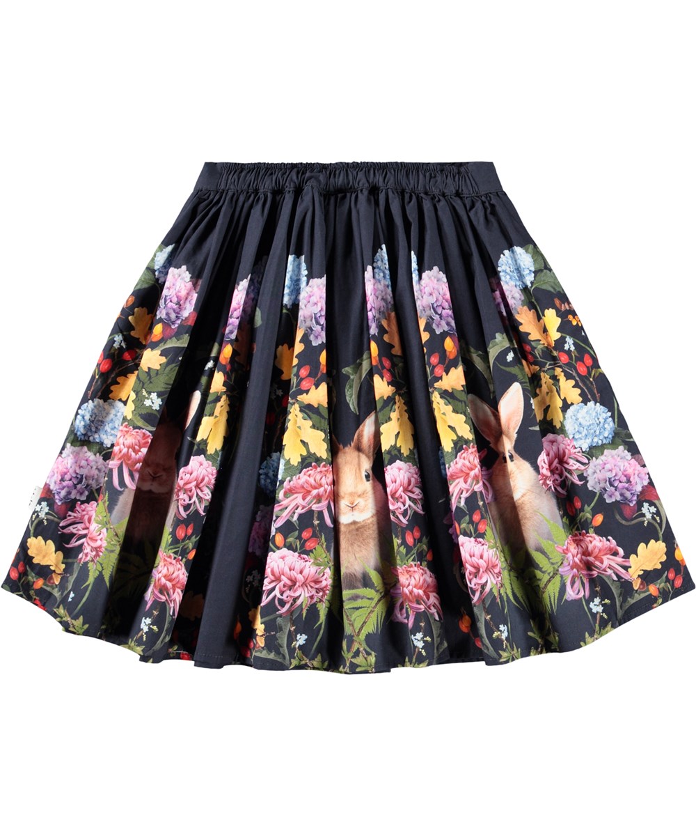 Bonnie - Nouveau Rabbit - Dark blue knee-length skirt for children made of organic cotton with a print of flowers and rabbits.