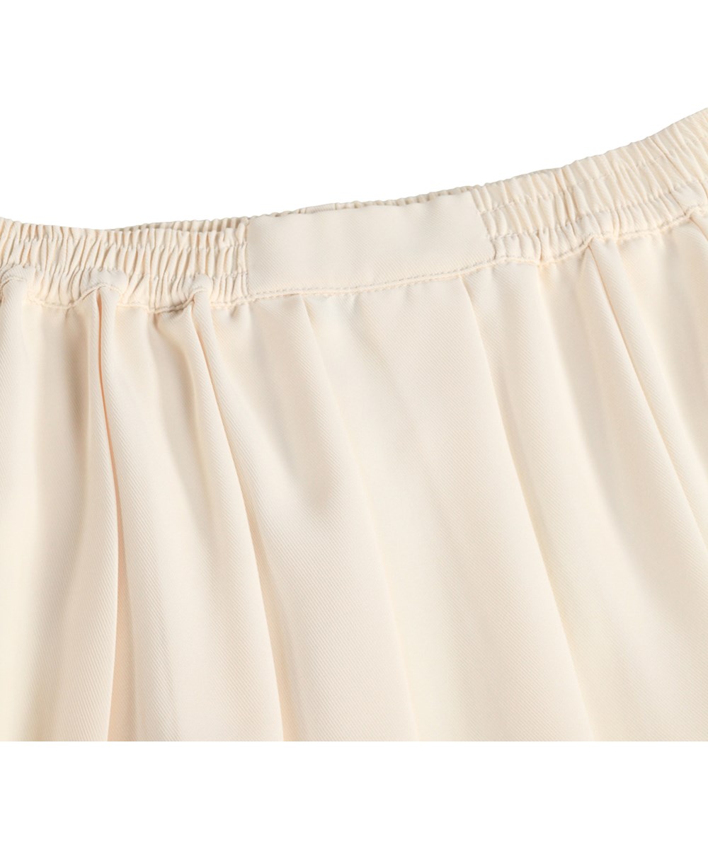 Breeta - Pearled Ivory - Off-white, sporty skirt for children with wide pleats