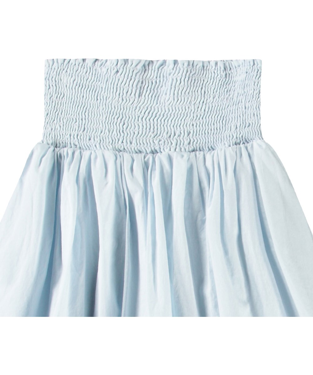 Brenna - Skywriting - Light blue long skirt with a wide smocked waistband for children.