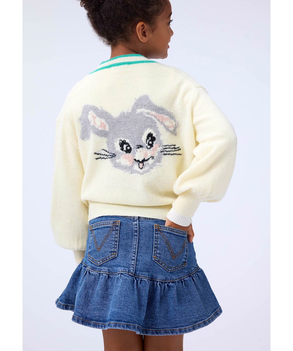 Gaby - Buttercream - Fun off-white cardigan for children made of a wool blend with an animal pattern.