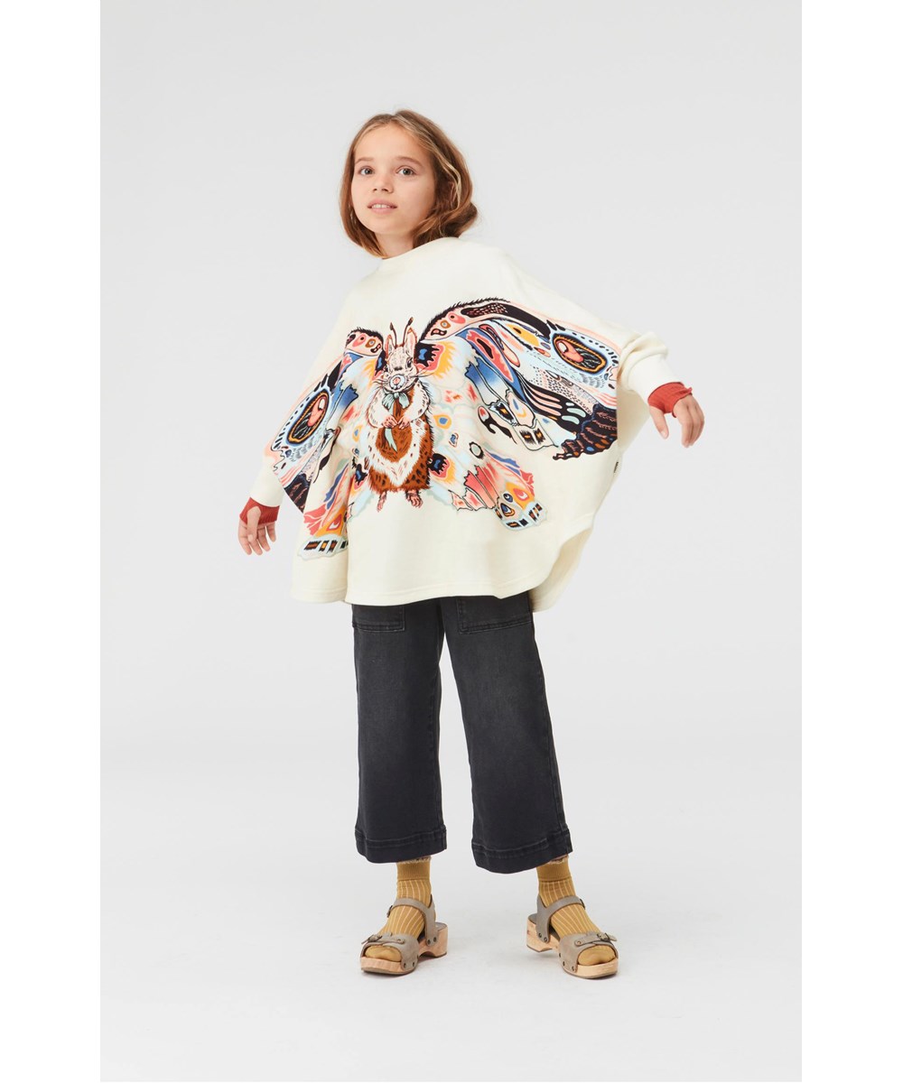 Marcella - Fluffy Wings - Light coloured poncho with squirrel print