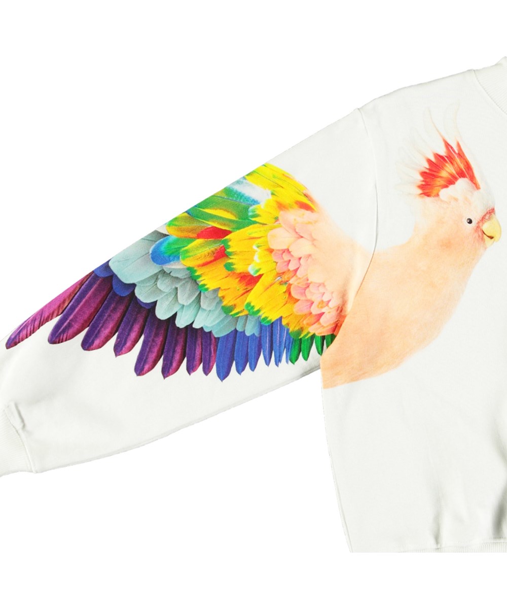 Marge - Magic Parrots - White sweatshirt with print for children in soft organic cotton with ribbed edges at the neck, sleeves, and at the bottom of the sweatshirt.