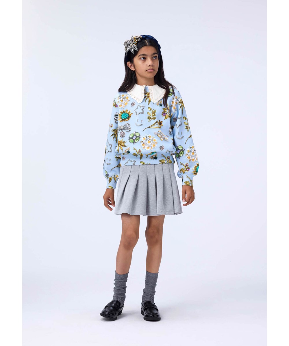 Marge - Royal Bling - Light blue sweatshirt made of organic cotton and a print of beautiful jewelry.