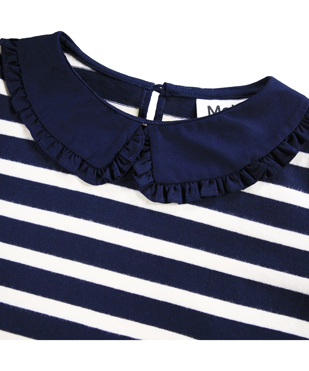 Rama - Blue Cream - Breton blue and white striped, long-sleeved top for children made of soft viscose cotton with a collar that fastens with a button at the back of the neck.