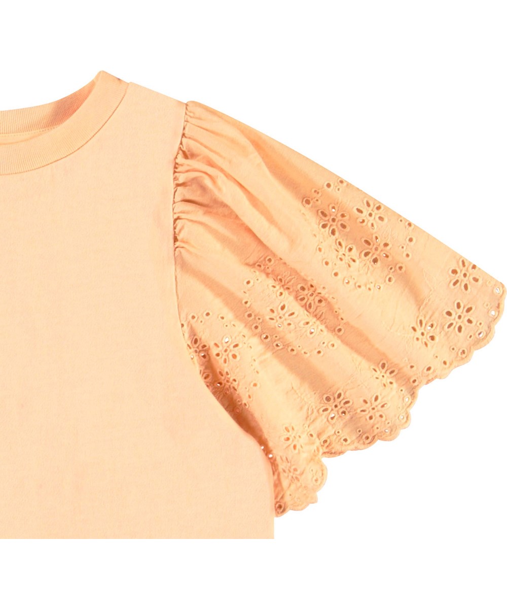 Ritza - Pale Melon - Light orange t-shirt for children in soft organic cotton with ribbed neckline and butterfly sleeves with broderie anglaise embroidery.