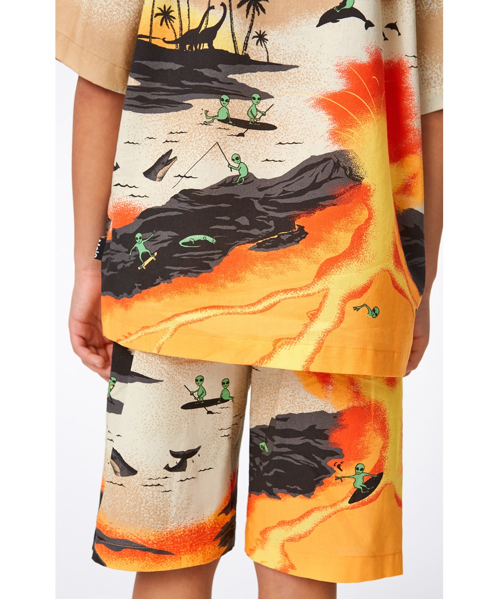 Rui - Alien Tourists - Gele en zandkleurige biologische blouse met surfende buitenaardse wezen.