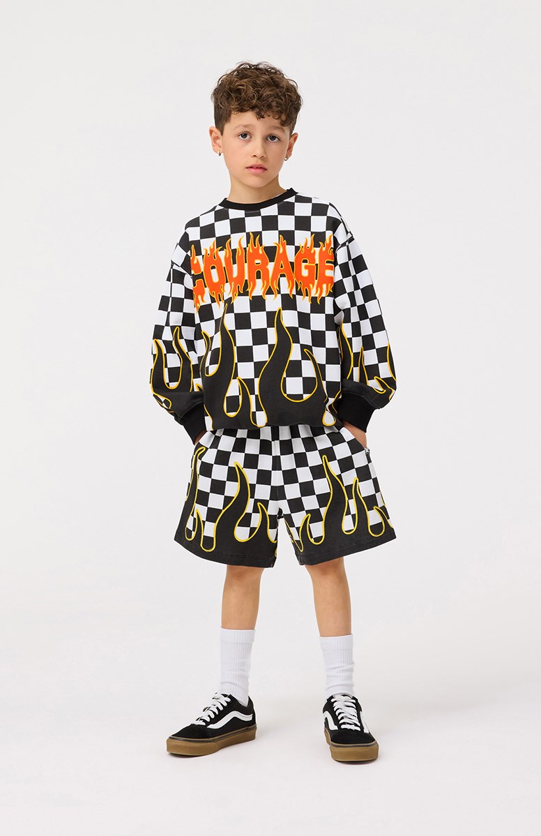 Monti - Check On Fire - Zwart en wit geblokte kindersweater met vlammen van zacht biologisch katoen met print en ribboord rond de hals, mouwen en onderkant.