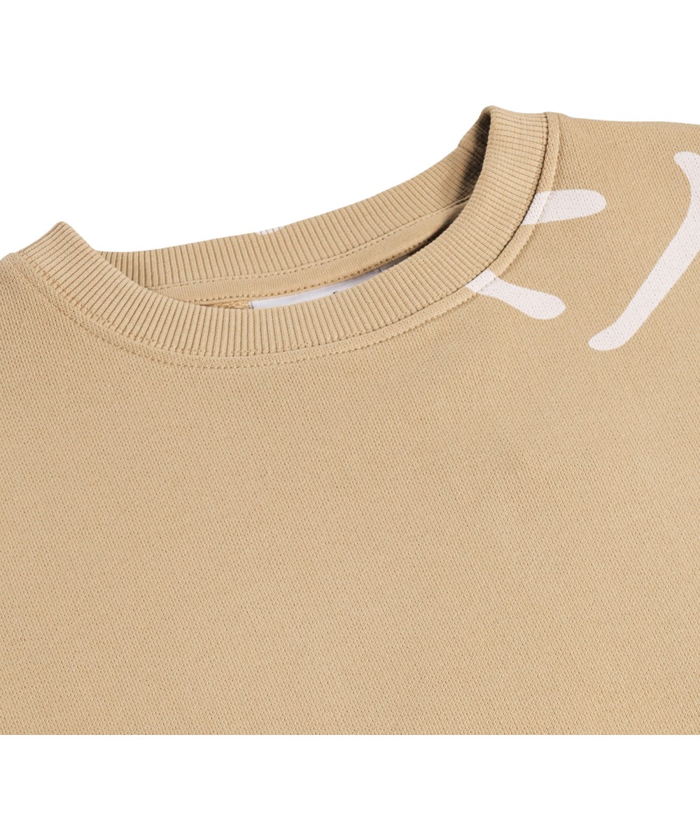 Monti - Desert Smiles - Beige kindersweater met een print gemaakt van biologisch katoen 