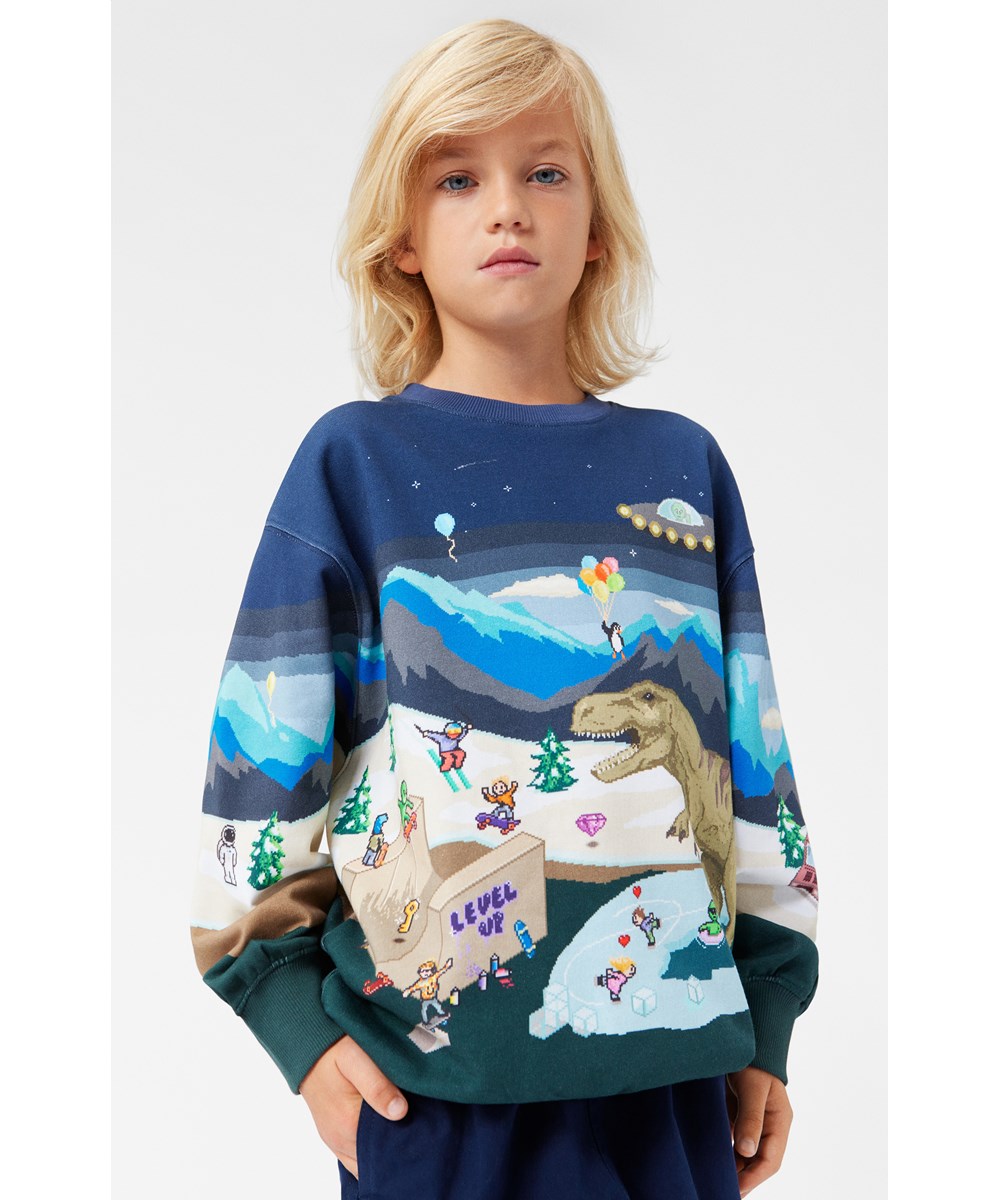Monti - Pixelscape - Kleurrijke sweater in een ruime pasvorm met een arcade print.