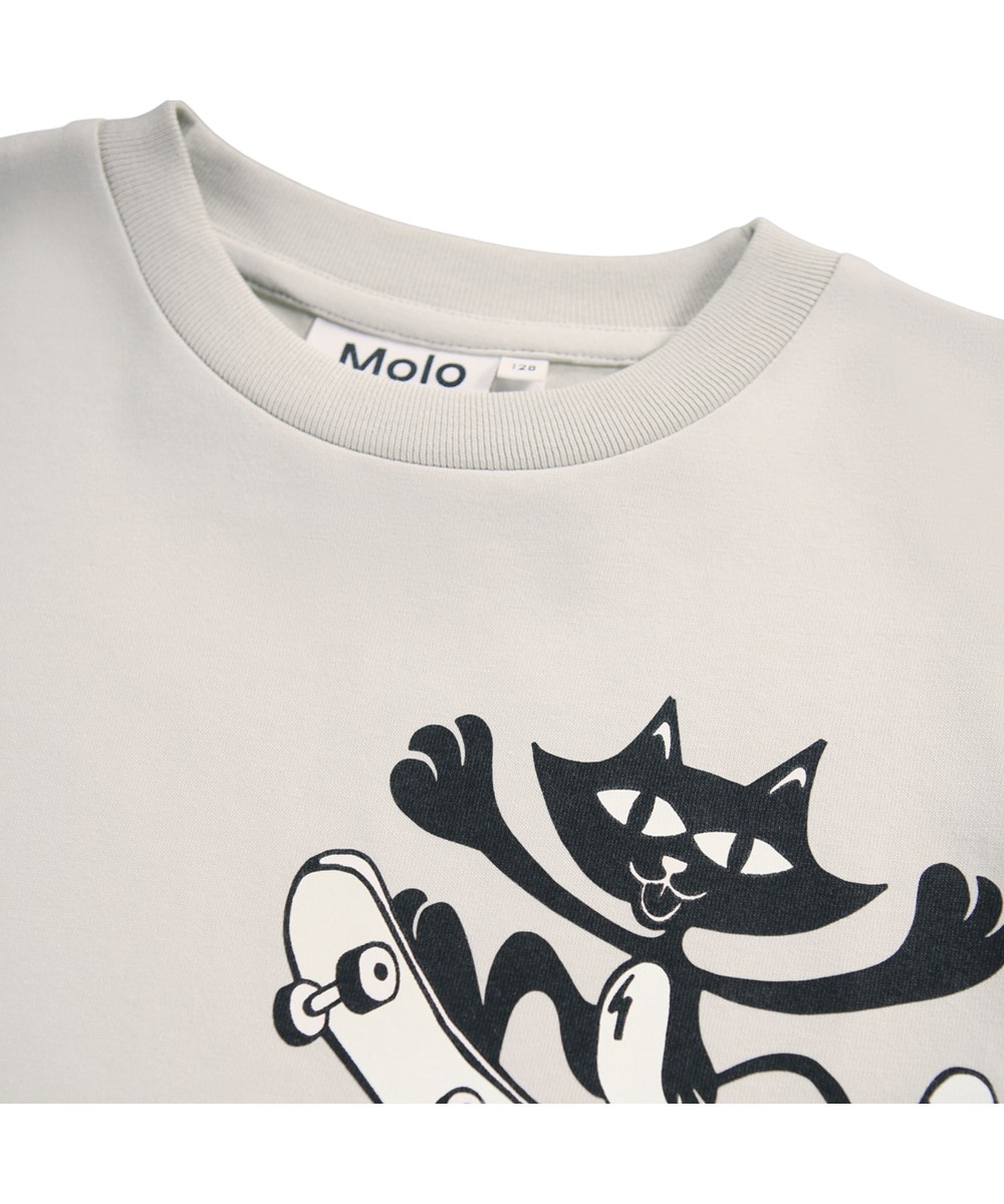 Rodney - A Lien To Tail - Beige oversized kinder t-shirt gemaakt van zacht biologisch katoen met een ribboord rond de hals.