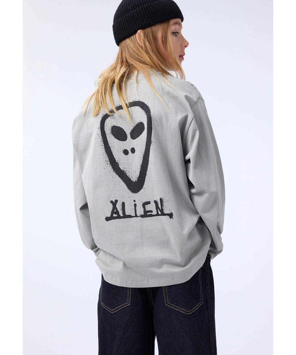 Rube - Forest Fog - Kaki longsleeve voor kinderen gemaakt van biologisch katoen met een ribboord rond de hals en op de voor- en acherkant een graffitt alien gezicht.