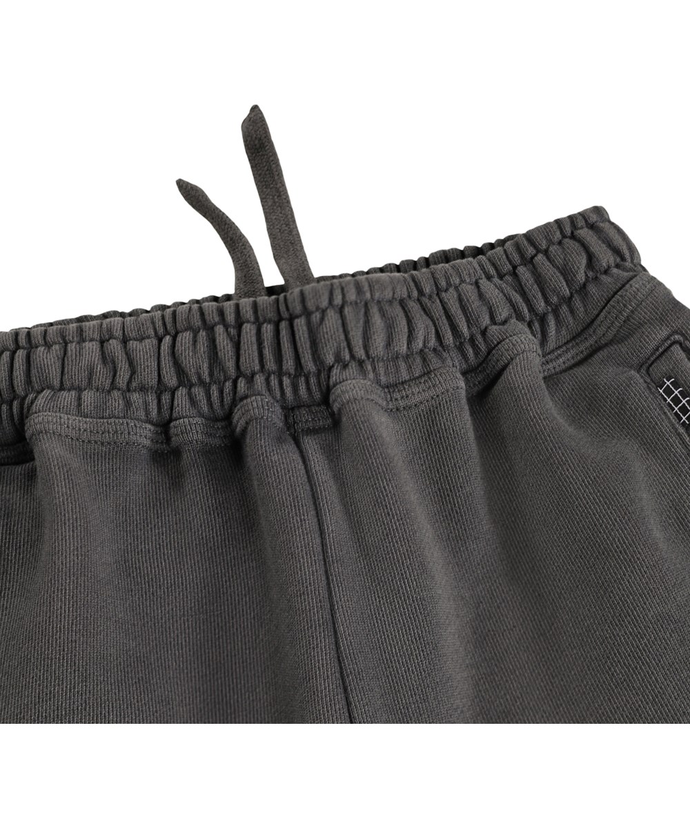 Adri - Raven - Graue Jogginghosen für Kinder aus Öko-Baumwolle mit einem Aufdruck.