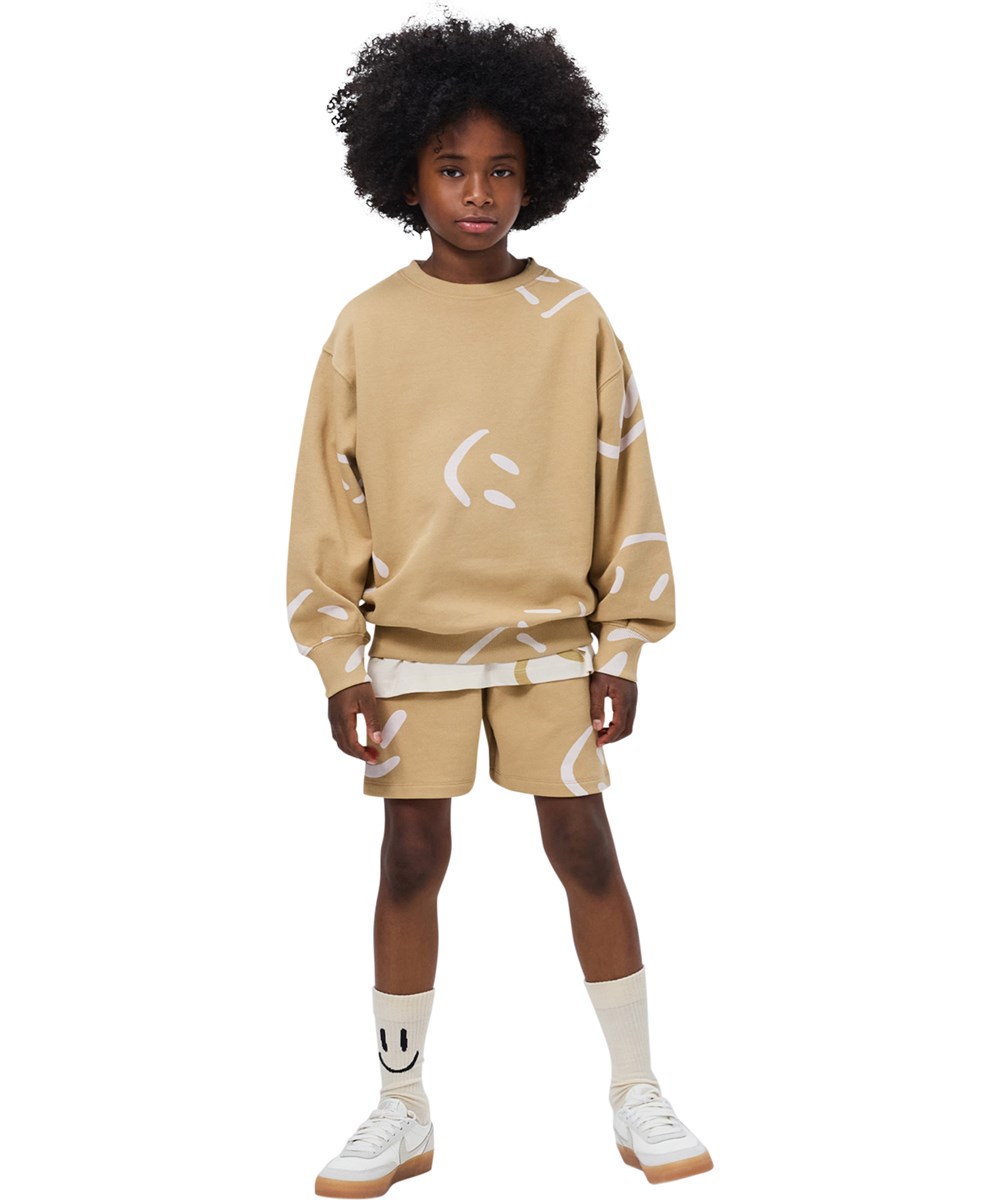 Amil - Desert Smiles - Beige Shorts für Kinder aus Öko-Baumwolljersey mit Druck