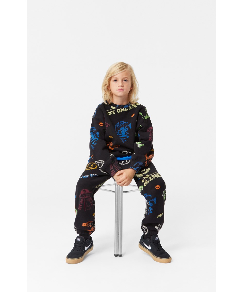 Monti - Cartooniverse - Schwarzes Sweatshirt mit lockerer Passform und Comic-Druck.