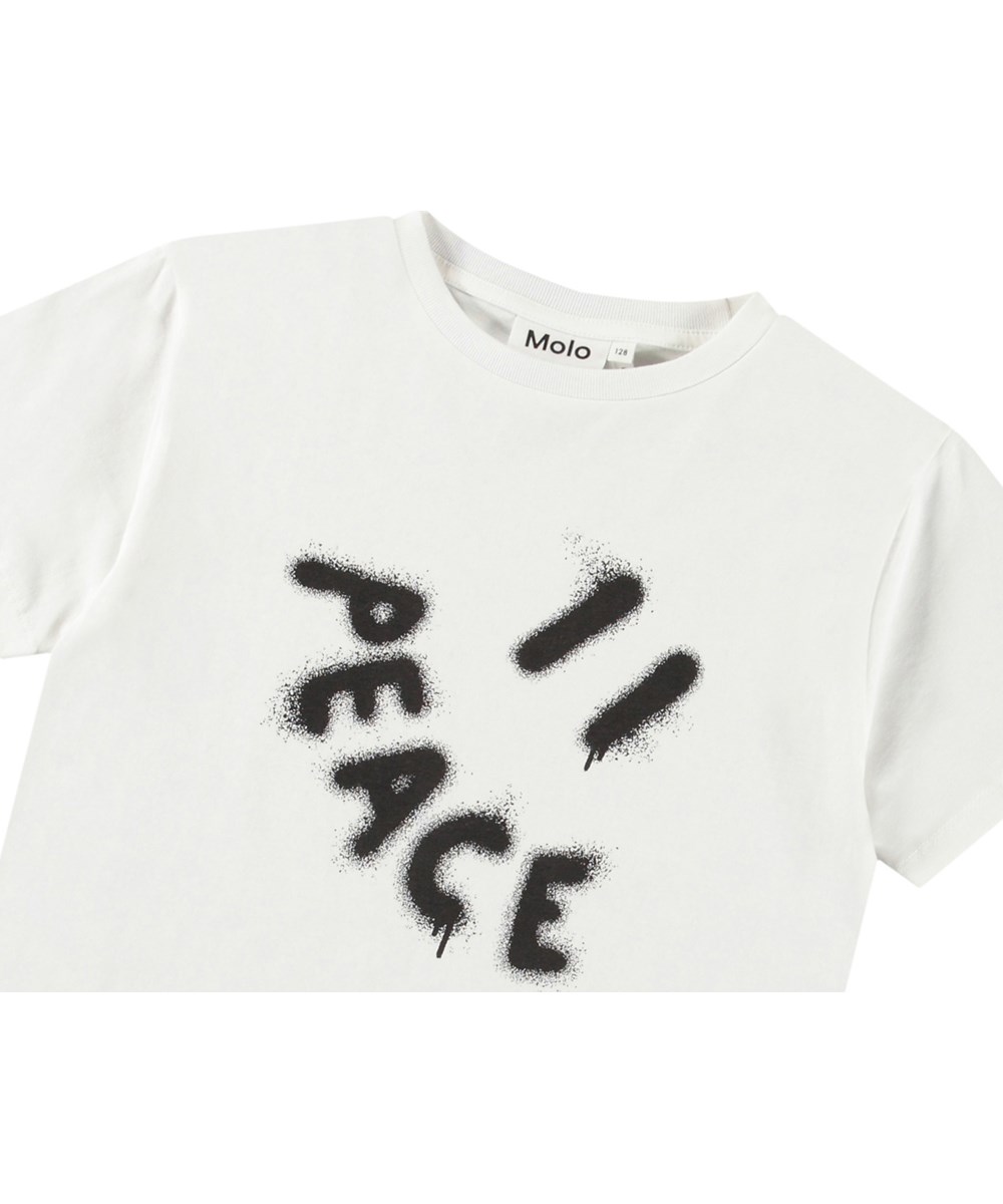 Riley - Peace Smile - Weißes T-Shirt mit Aufdruck für Kinder aus weicher Öko-Baumwolle mit kurzen Ärmeln und geripptem Ausschnitt.