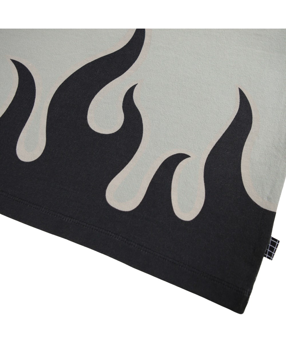 Rube - Heated - Graues Langarmshirt für Kinder aus Öko-Baumwolle mit geripptem Ausschnitt und Ärmeln sowie einem schwarzen Flammenmuster an der Taille.
