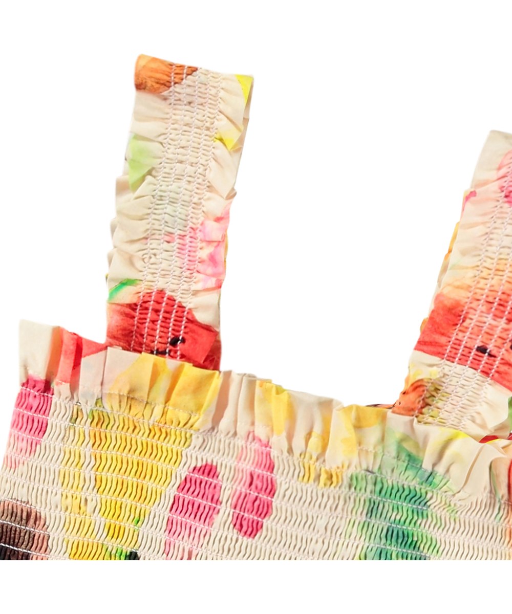 Rolfia - Painted Fruits - Off-weißes Crop-Top für Kinder aus Öko-Baumwolle mit einem Druck bunter exotischer Früchte.