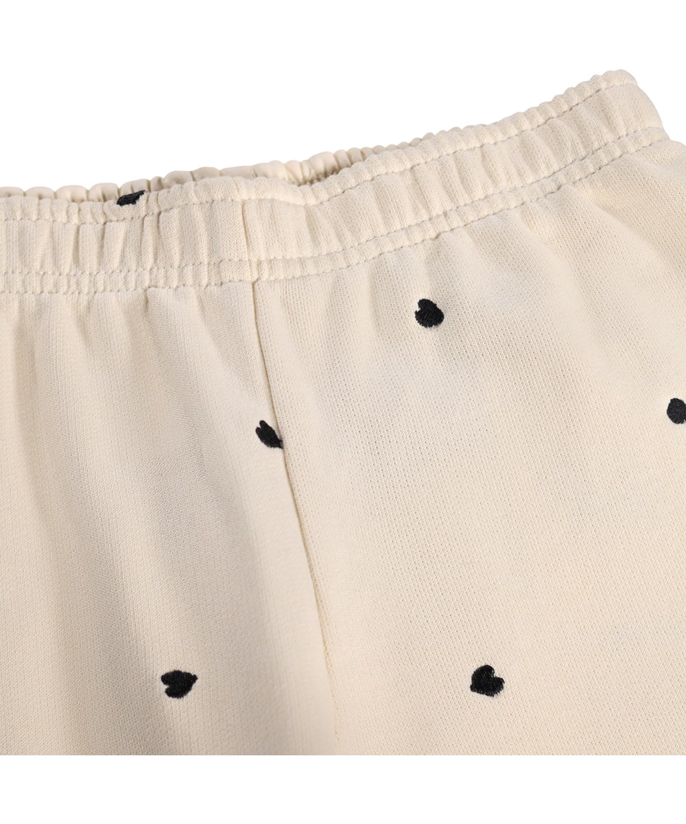 Anna - Confetti_Sand - Off-weiße Kinderhosen aus Bio-Baumwolljersey mit elastischem Bund