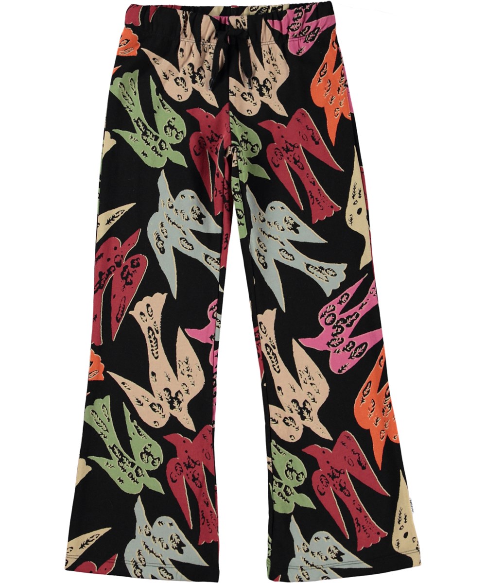 Annelisa - Studio Birds - Schwarze Jerseyhose aus Öko-Baumwolle mit einem Allover-Schwalbenmuster.