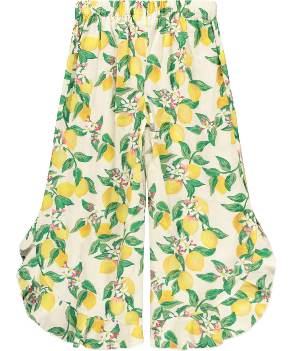 Aretha - Citrus - Gelbe, lockere Hosen für Kinder aus Bio-Baumwolle mit Zitrusfrüchte-Print.