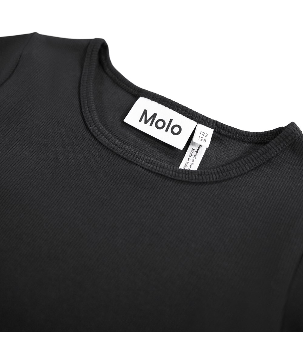 Casie Warm - Made Of Stardust - Langärmeliges schwarzes Kleid für Kinder aus Öko-Baumwolle mit einem Rock aus gebürsteter Baumwollflanell.