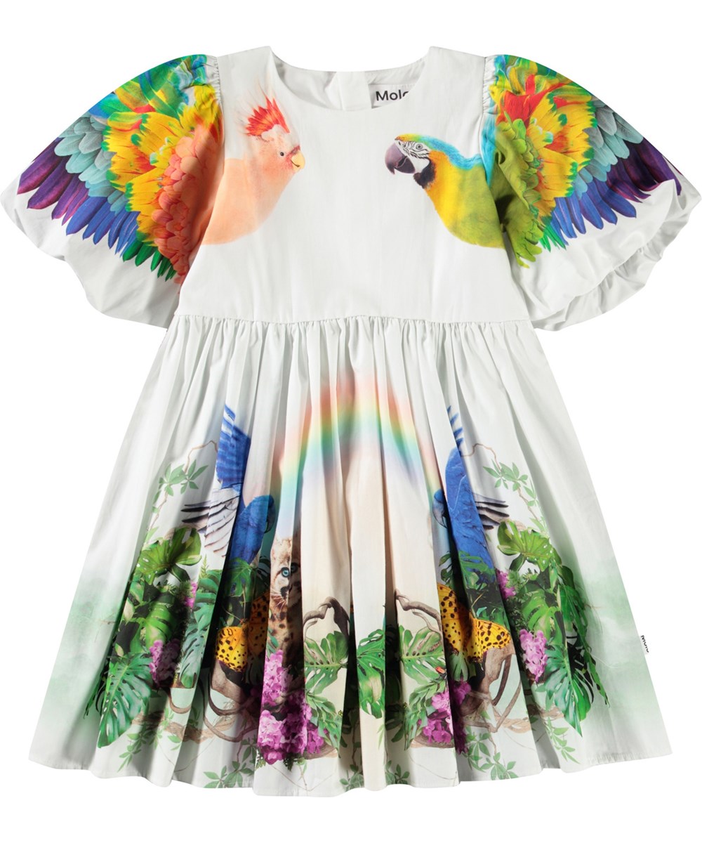 Chica - In The Jungle - Weißes knielanges Kleid für Kinder aus Öko-Baumwolle mit Puffärmeln und Rundhalsausschnitt.