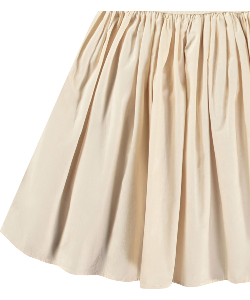 Christal - Brazilian Sand - Rosa Kleid für Kinder aus Öko-Baumwolle mit einem eng anliegenden gerippten Jersey-Oberteil, Rundhalsausschnitt und einem voluminösen, kreisförmig geschnittenen Rock aus Baumwollpopeline.