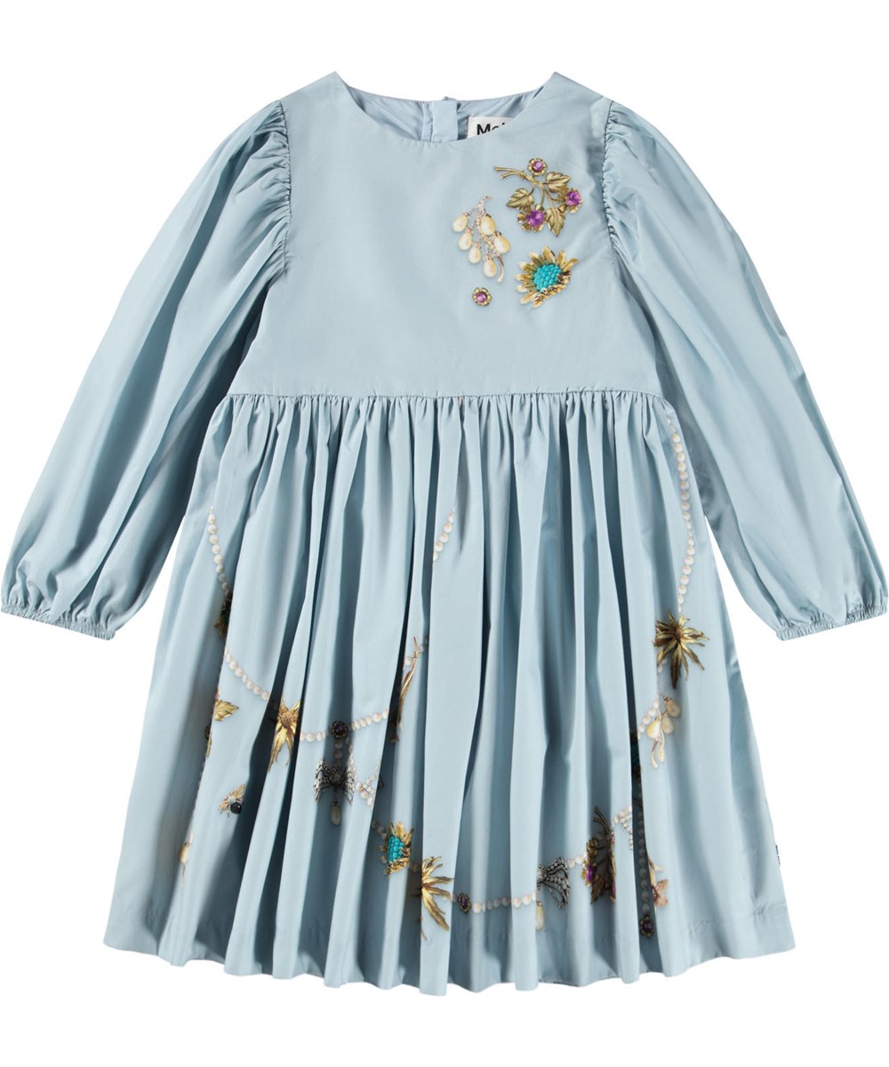 Cilja - Broches - Knielanges hellblaues Kleid für Kinder aus Öko-Baumwollpopeline mit einem Schmuckmuster.