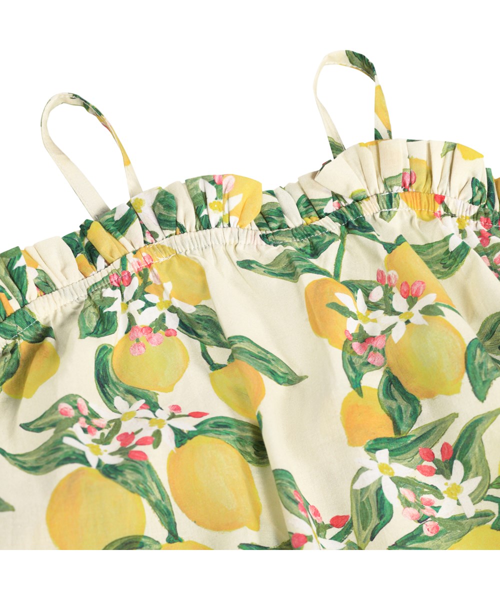 Connie - Citrus - Gelbes Trägerkleid für Kinder mit Zitrusdruck aus Bio-Baumwolle.
