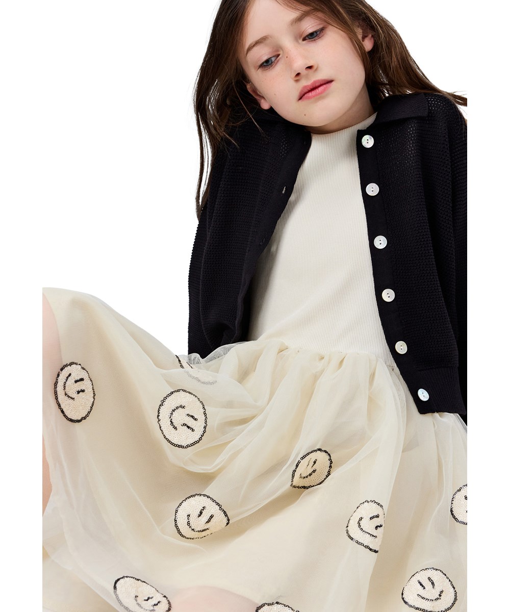 Cyrus - Summer Sand - Off-White-Kleid für Kinder mit langen Ärmeln und einem Tüllrock mit fröhlichen Paillettenblumen