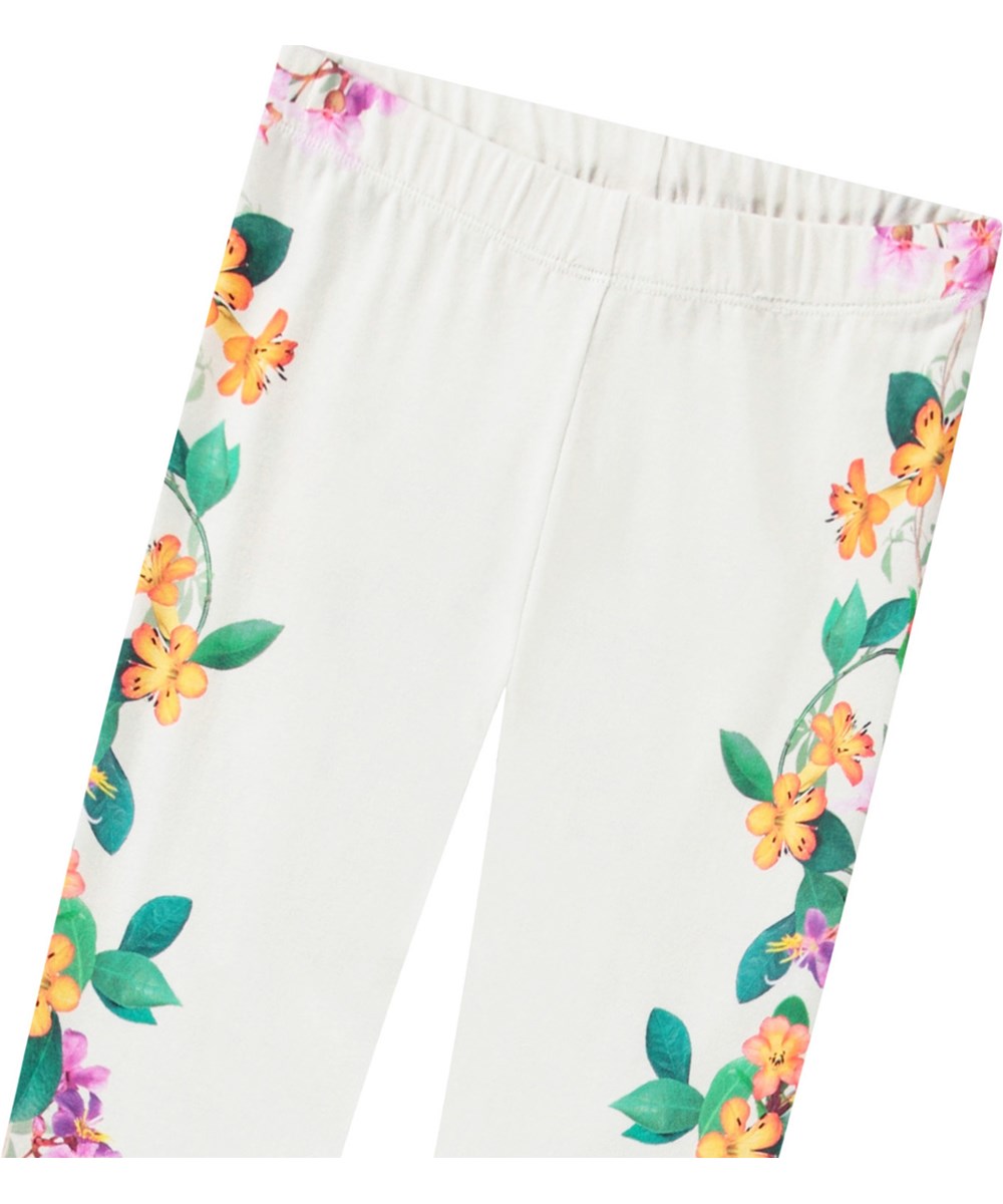 Niki - Jungle Flowers - Weiße Leggings mit Druck für Kinder aus dehnbarem Öko-Baumwolle mit elastischem Bund.