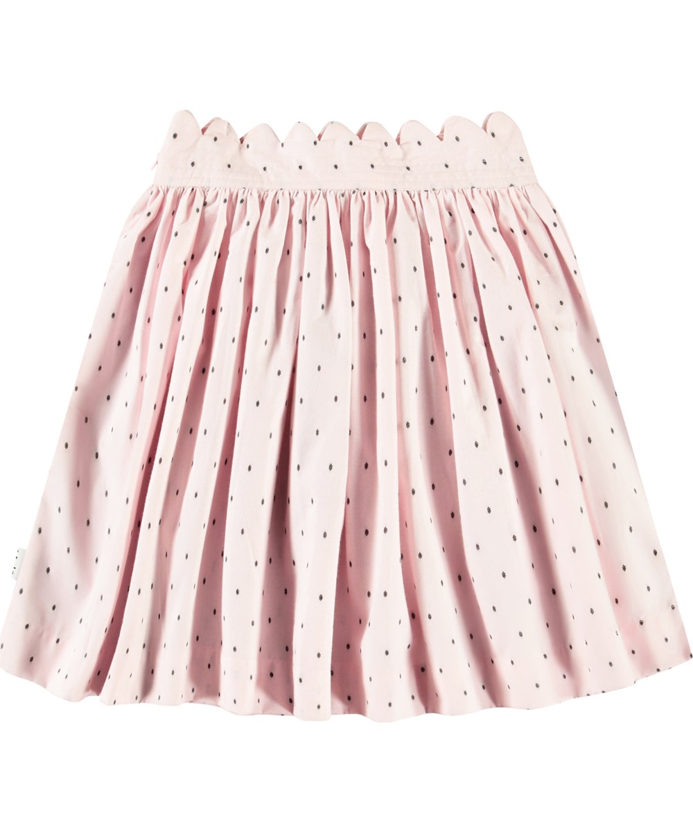 Bettina - Charlotte Pink - Rosa Rock für Kinder aus Öko-Baumwolle, mit gewebten schwarzen Punkten und zarten Details.