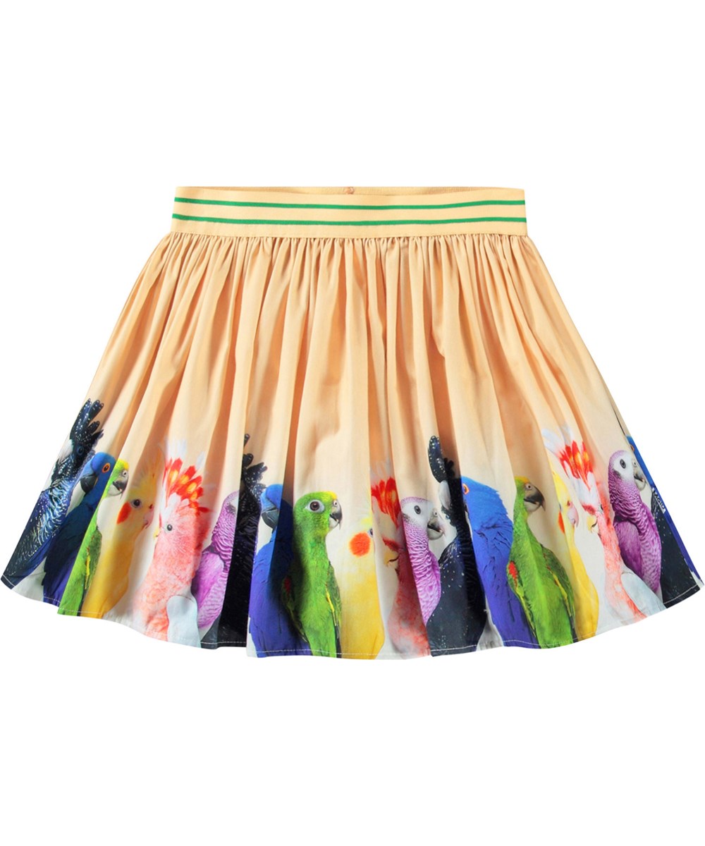 Brenda - Rainbow Parrots - Leichter orangefarbener kreisförmiger Rock aus Öko-Baumwolle mit einem Druck von kleinen bunten Papageien für Kinder.