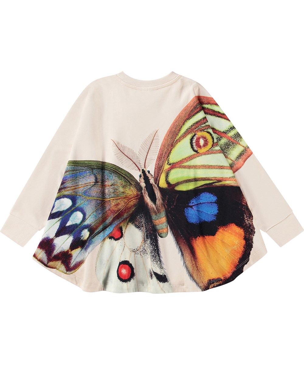 Marcella - Giant Butterfly - Off-weißer Oversize-Poncho aus Öko-Baumwolle mit Schmetterlingsmuster.