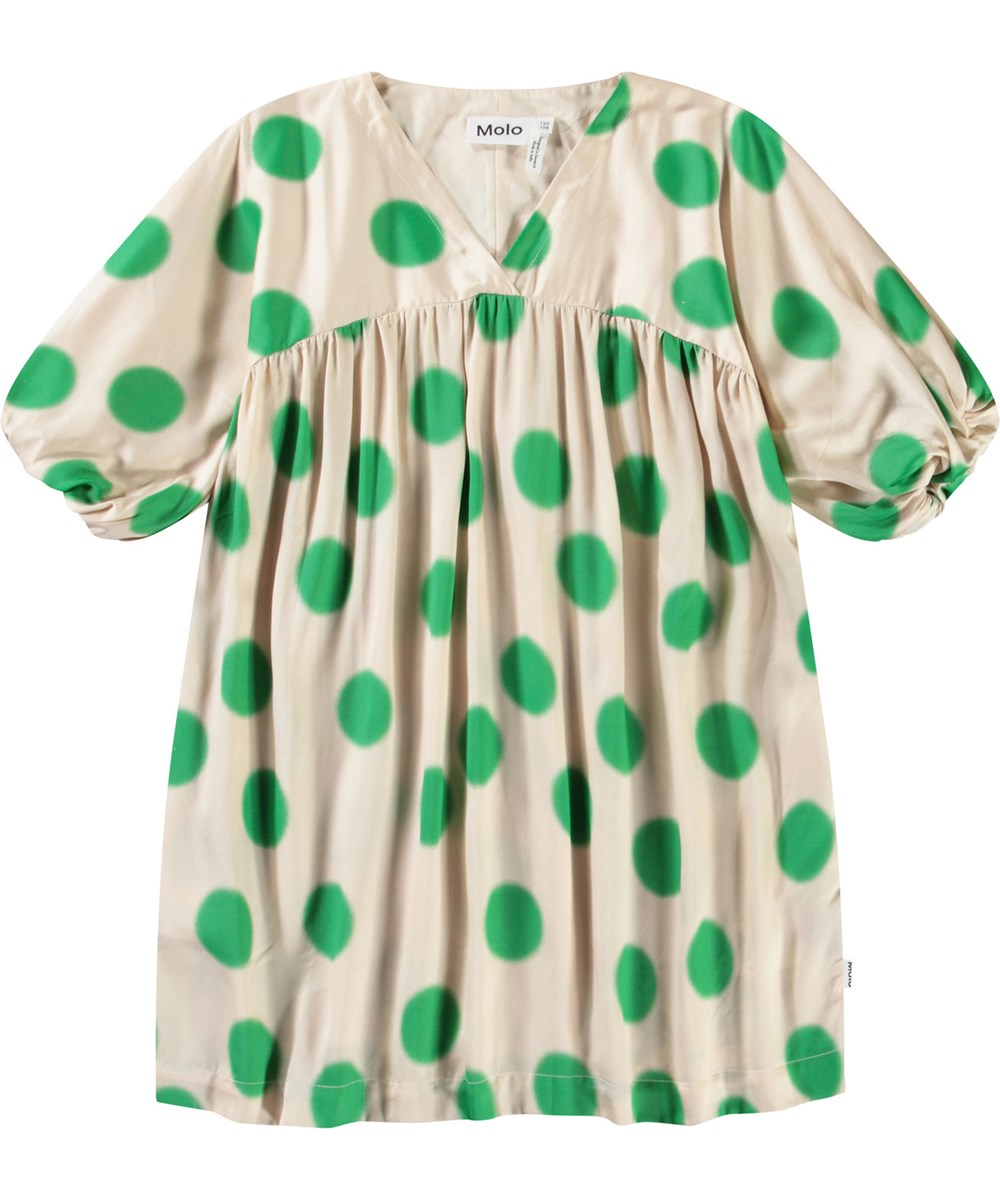 Camellia - Green Dots - Beige kinderjurk van viscose met een v-hals en grote groene stippen.