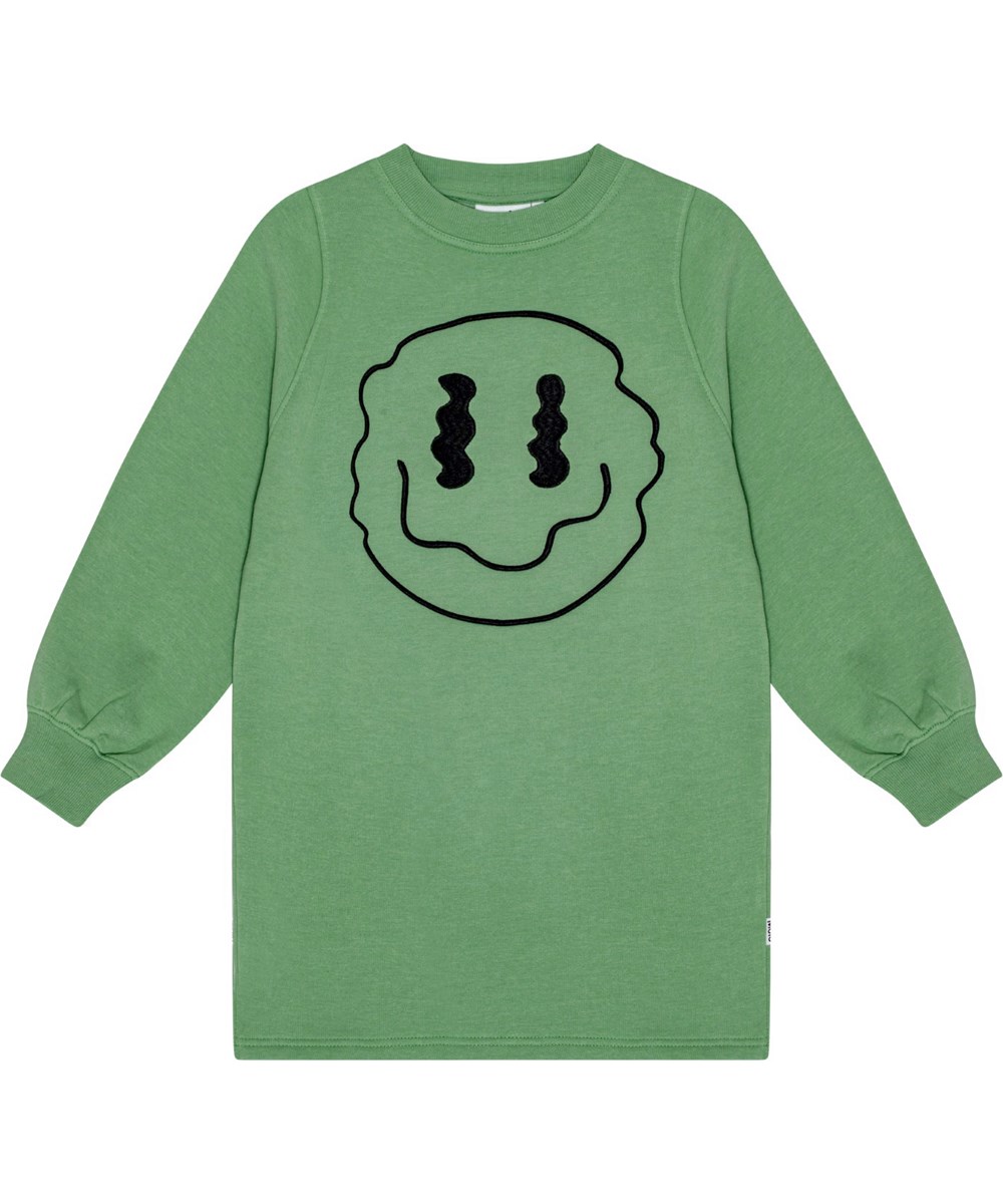 Corvina - Jadesheen - Zachte olijfgroene jersey jurk met sprankelende zwarte print van een lachend gezicht.