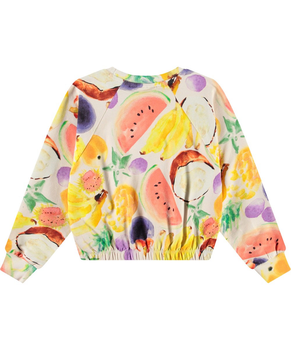Malinda - Fruit Salad - Gebroken witte kindersweater van zacht biologisch katoen met een print en ribboord rond de hals en mouwen.