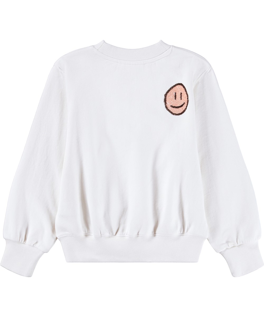 Marge - Buttercream - Gebroken witte kindersweater gemaakt van biologisch katoen met geborduurde paillettengezichten.