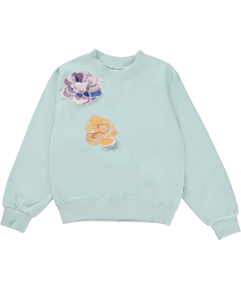 Marge - Pool Blue - Blauwe biologische trui met bloemen emblemen