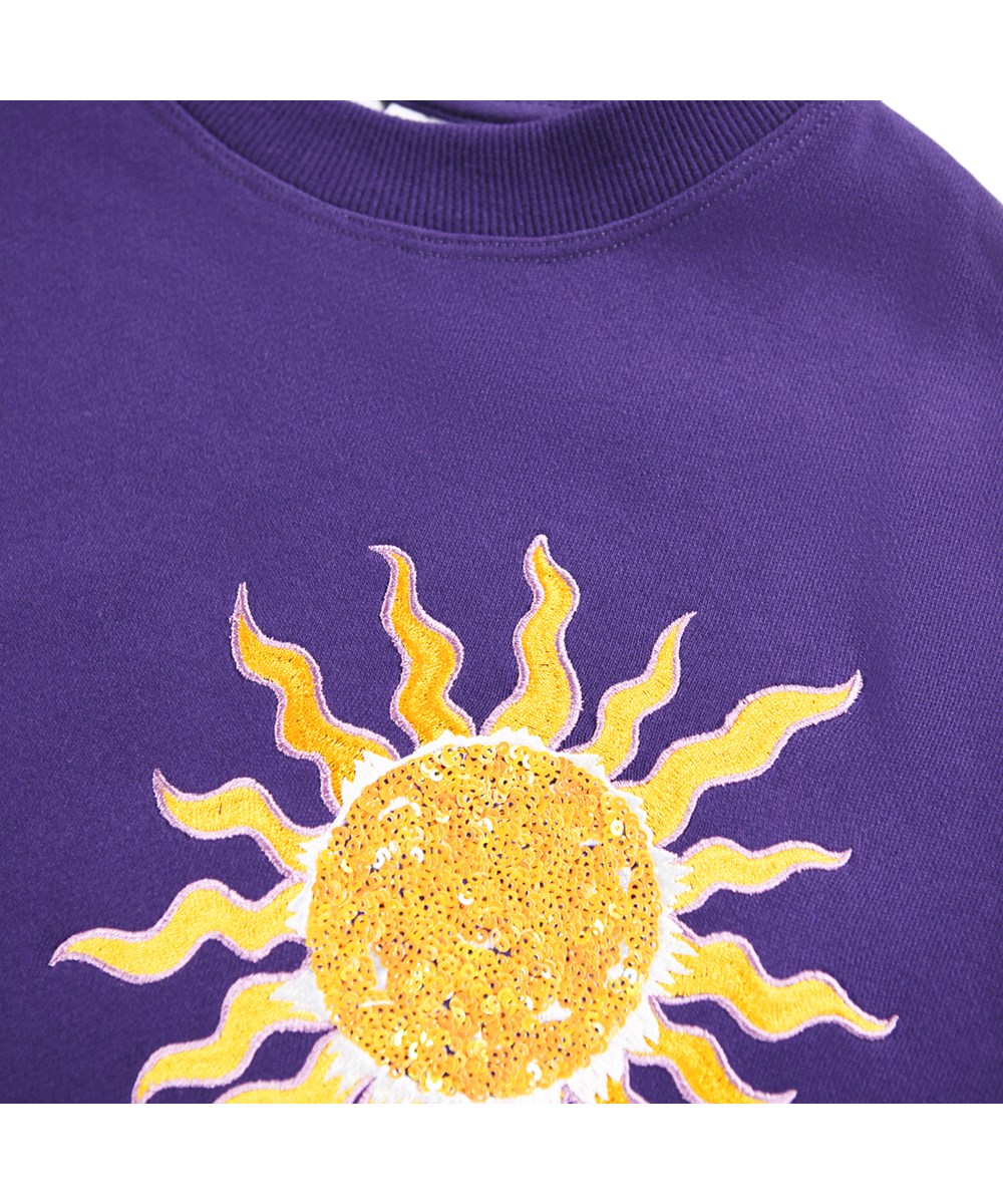 Marika - Sparkle Space - Paarse kindersweater gemaakt van biologisch katoen met een borduursel van de ruimte.