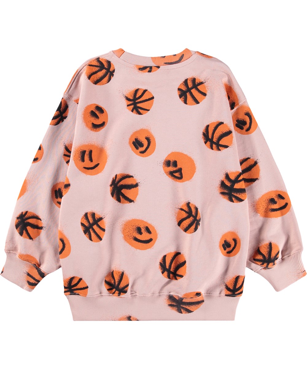 Monti - Basketball Rose - Roze kindersweater met een print van basketballen gemaakt van biologisch katoen .