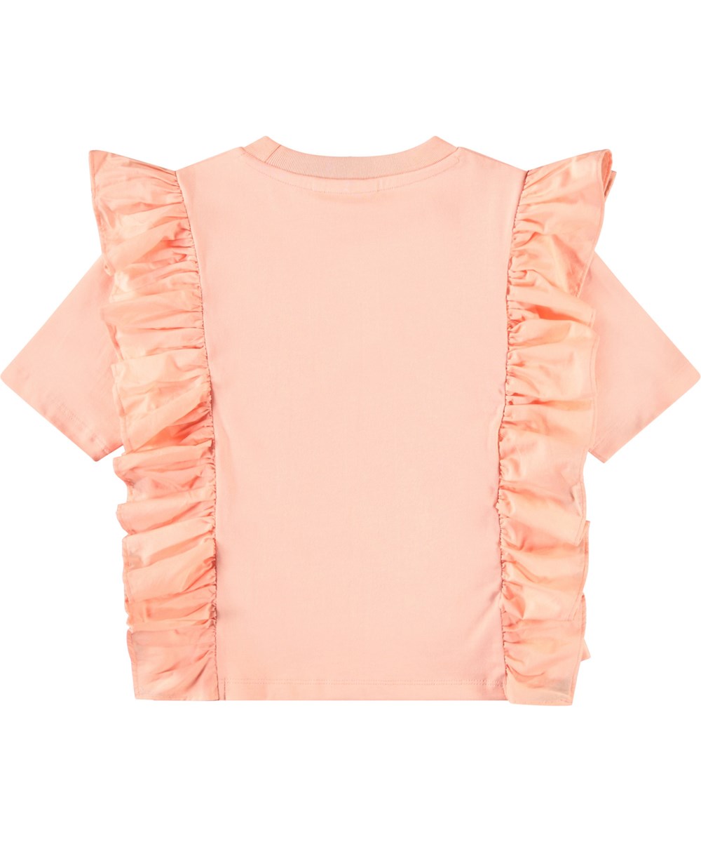 Riva - Peach - Lichtoranje kinder t-shirt in zacht biologische katoen met ribboord rond de hals en ruches.