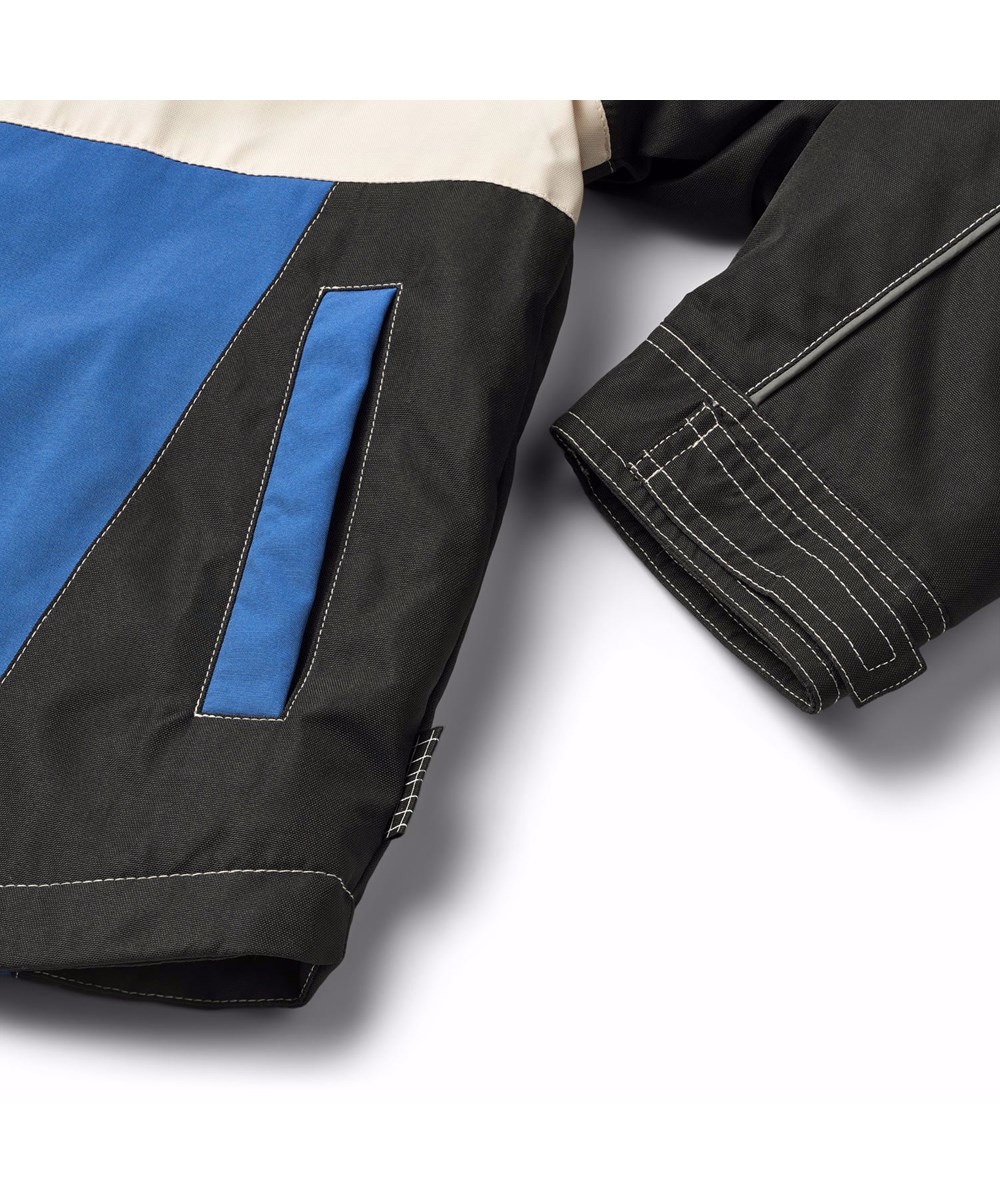 Haddix - Black - Jacken für Kinder in Schwarz, Blau und Off-Weiß, inspiriert von der Motocross-Welt, mit Klettverschluss-Patches auf der Brust und dem Rücken.