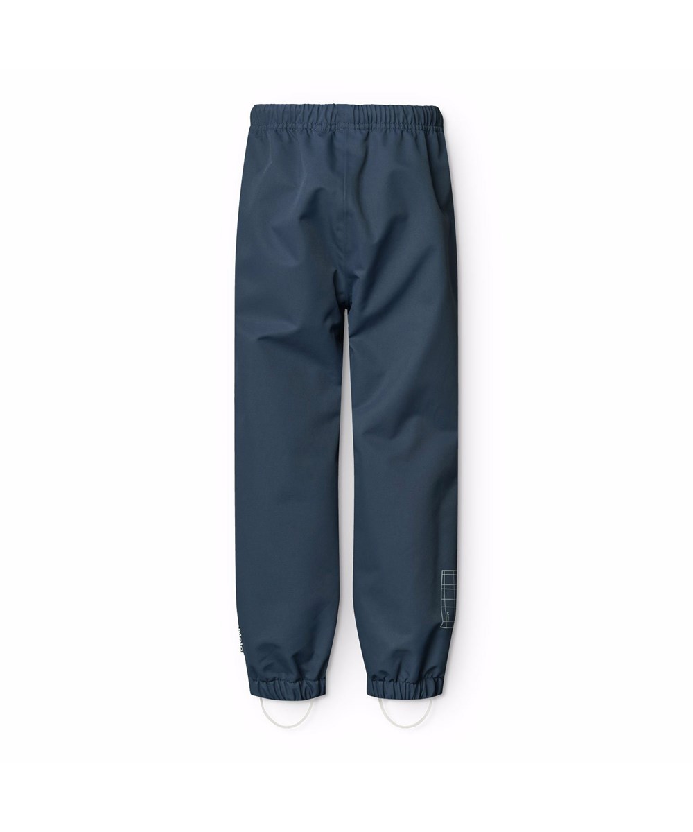 Waits - Mood Blue - Dunkelblaue wind- und wasserdichte Regenhosen für Kinder aus strapazierfähigem und recyceltem Polyester.