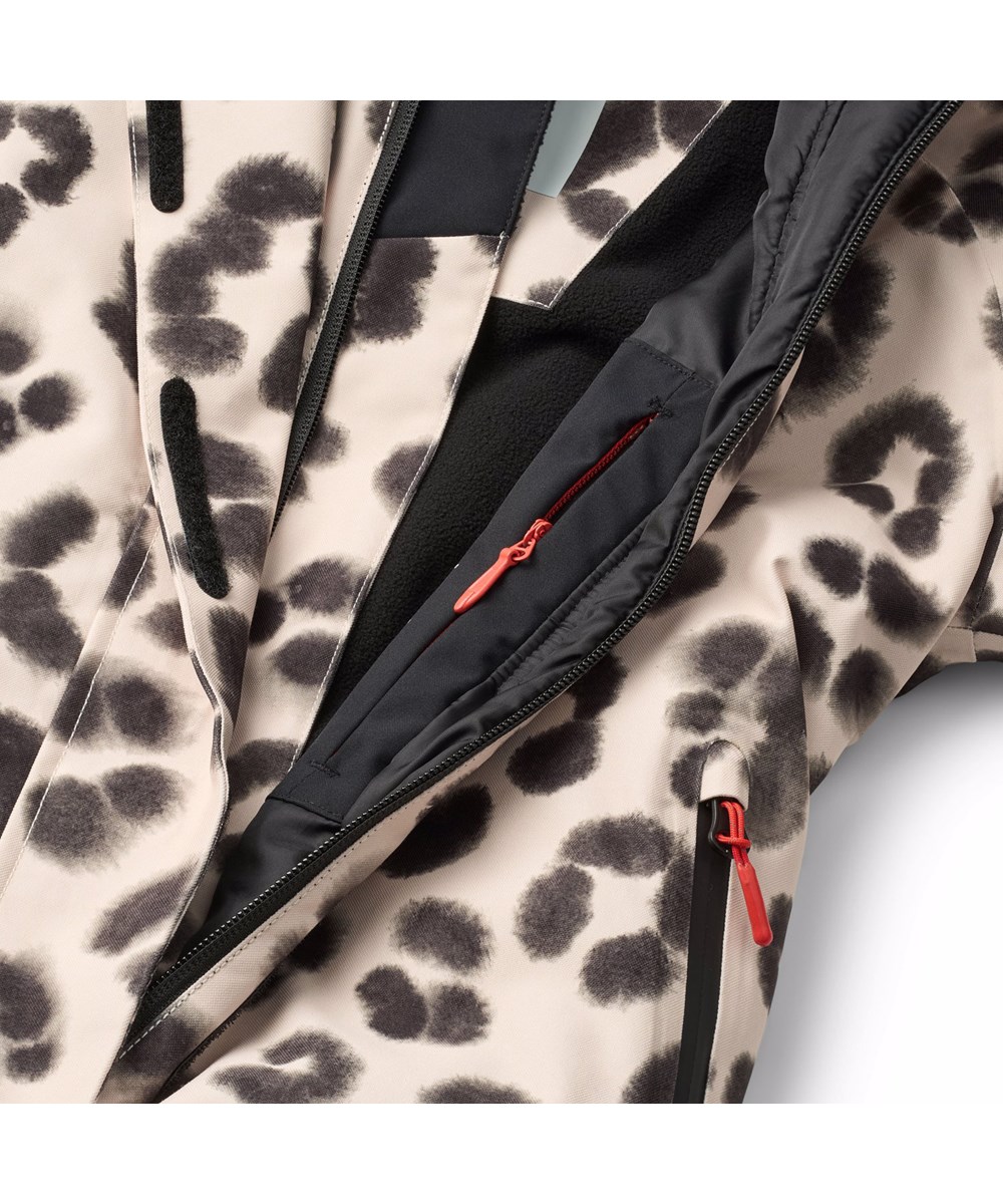 Hux - Snow Leo - Wind- und wasserdichter Overall in einem einzigartigen Leopardenmuster für einen kalten Winter oder Skiurlaub aus recyceltem Polyester und gefüttert mit 3M™ Thinsulate™.