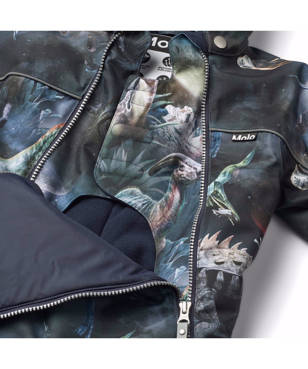 Pyxis - Dino In Space - Blaue Kinder-Schneeanzug aus recyceltem Polyester mit einem Druck von Dinosauriern im Weltraum.