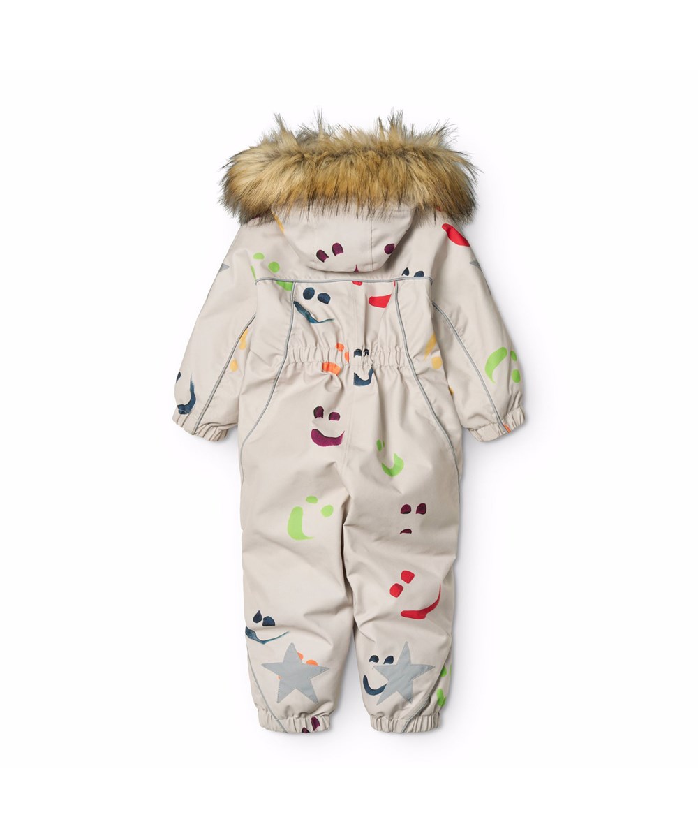 Pyxis Fur - Arty Emotions - Beiger wind- und wasserdichter Schneeanzug für einen kalten Winter mit einem Druck von bunten lächelnden Gesichtern aus recyceltem Polyester und gefüttert mit 3M™ Thinsulate™.