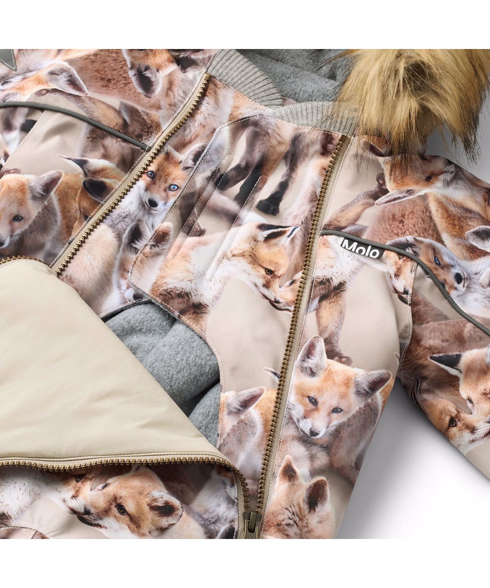 Pyxis Fur - Playing Foxes - Wind- und wasserdichter Schneeanzug für einen kalten Winter mit einem Druck von Fuchswelpen in Brauntönen aus recyceltem Polyester und gefüttert mit 3M™ Thinsulate™.